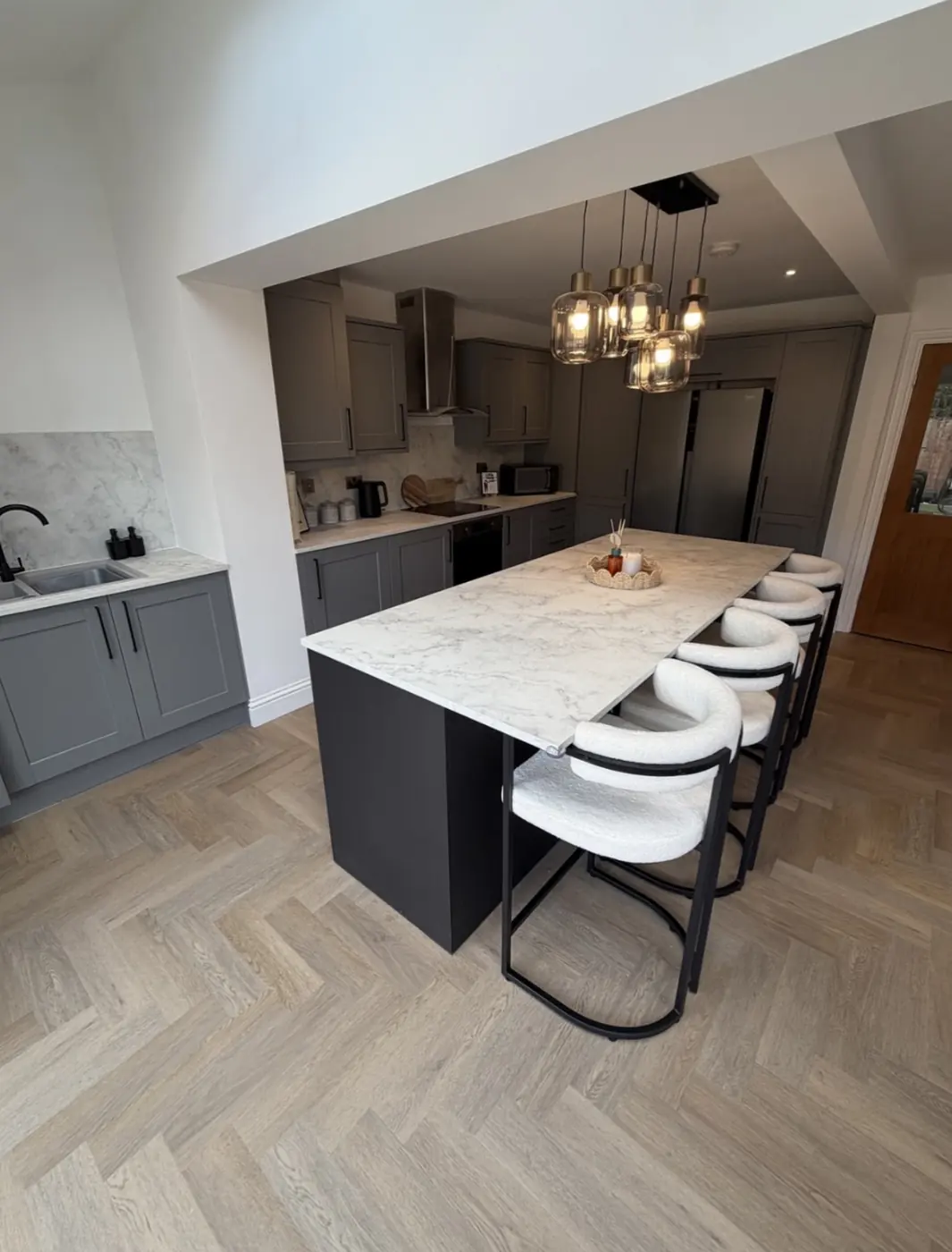 Kitchen extension with island breakfast bar and herringbone floor