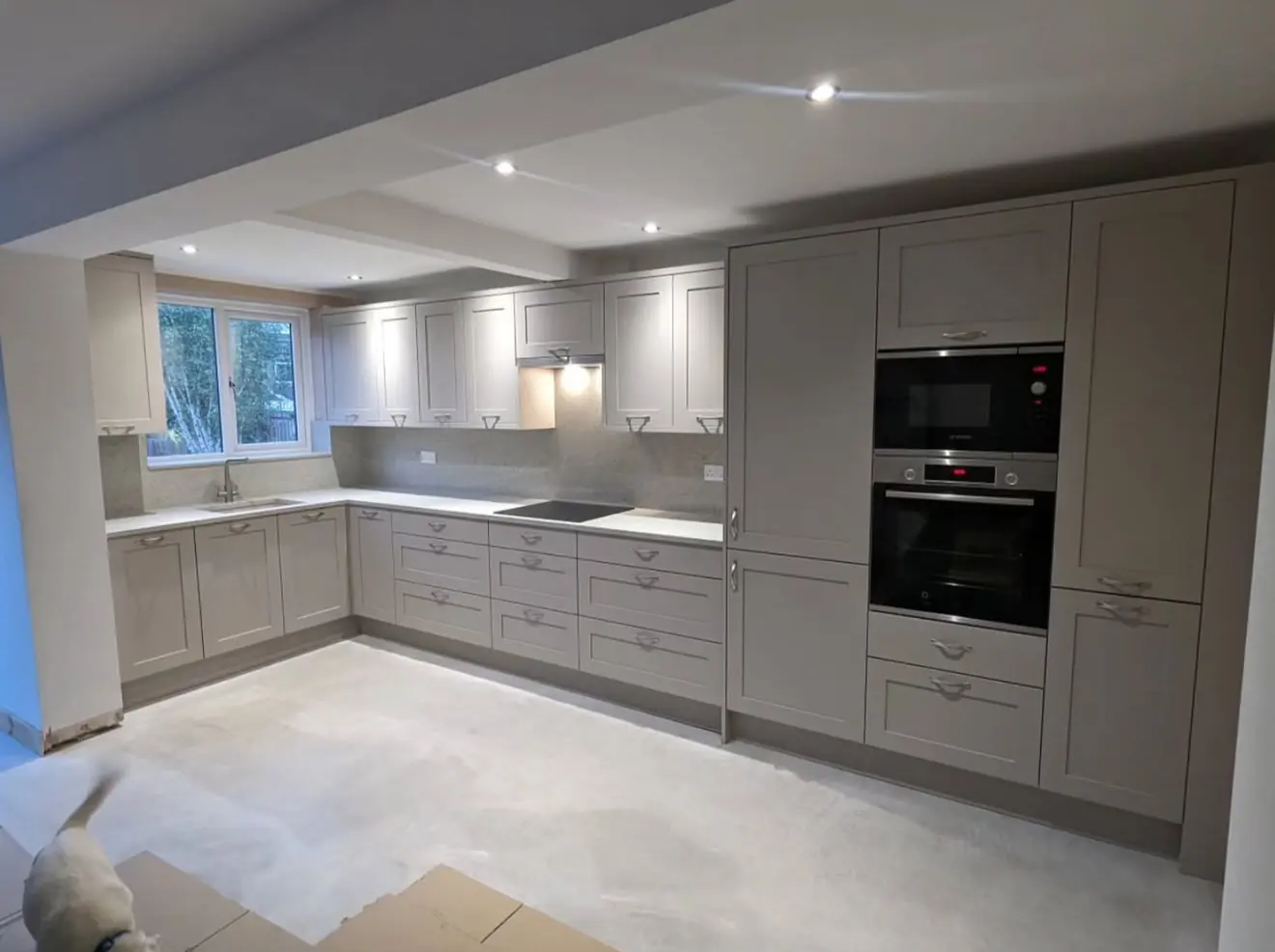 Stone shaker kitchen installation with tall oven housing